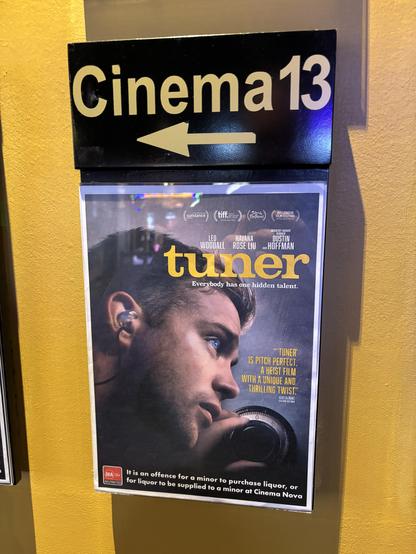 Small poster for the movie, beneath a sign indicating the way to Cinema 13.
