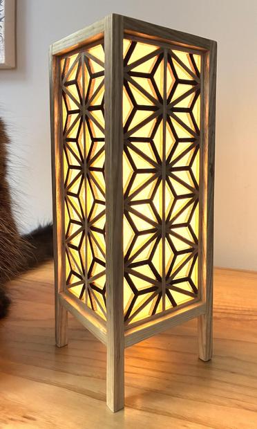 The lit table lamp seen from a 45 degree angle.