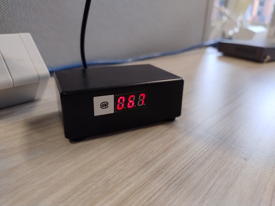 A small black box with a three digit display showing 067, prefixed with an @ symbol on a sticky label