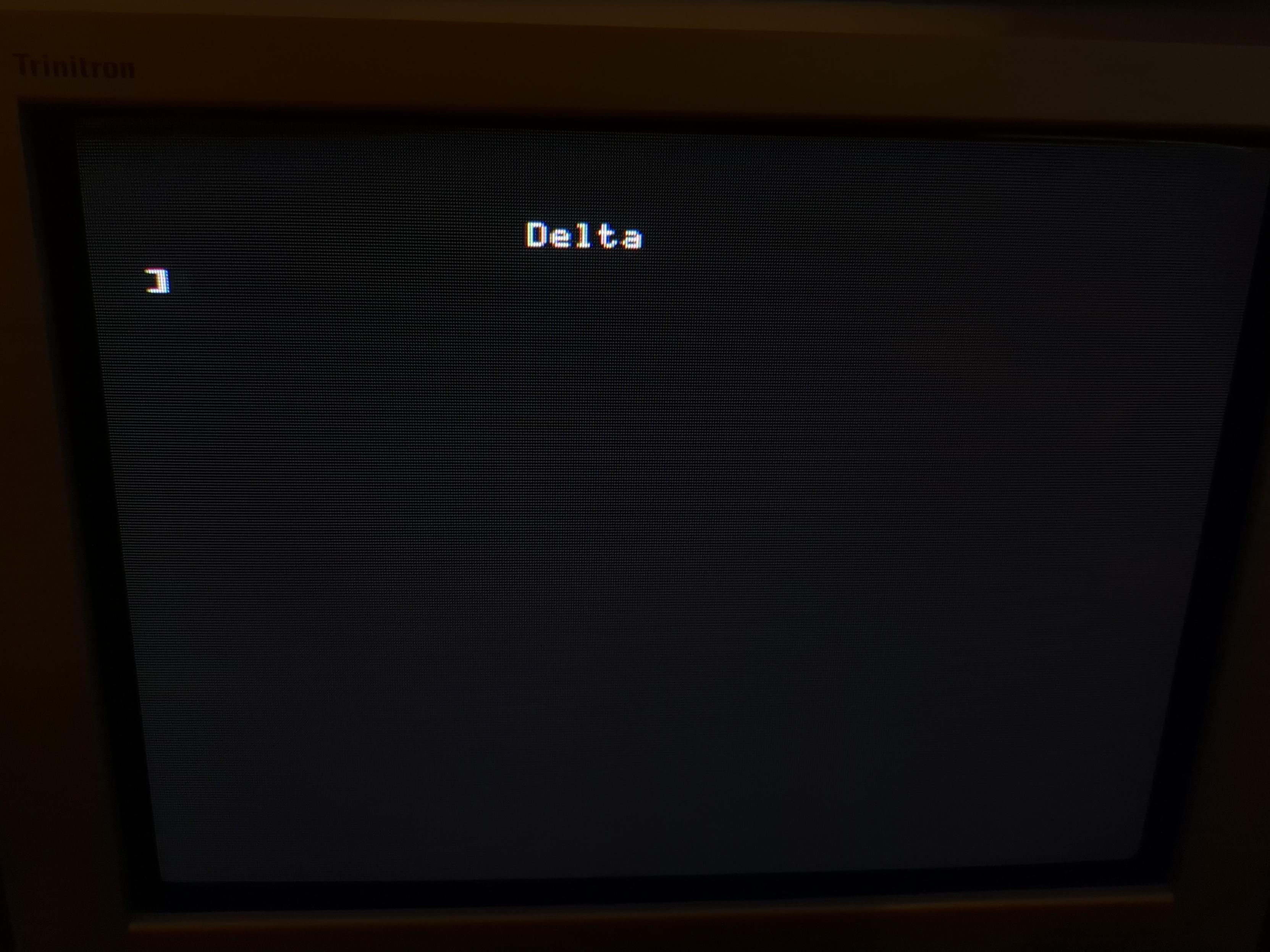 Photo of a CRT screen showing a white text on black background.

The white text says "Delta"
A prompt follows: ]