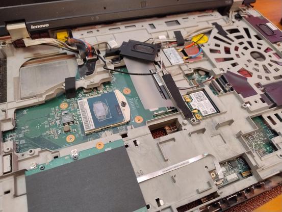 A dismantled laptop with the CPU exposed 