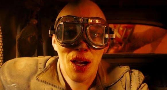 Screenshot of a frame from Fury Road where Nux yells what a lovely day