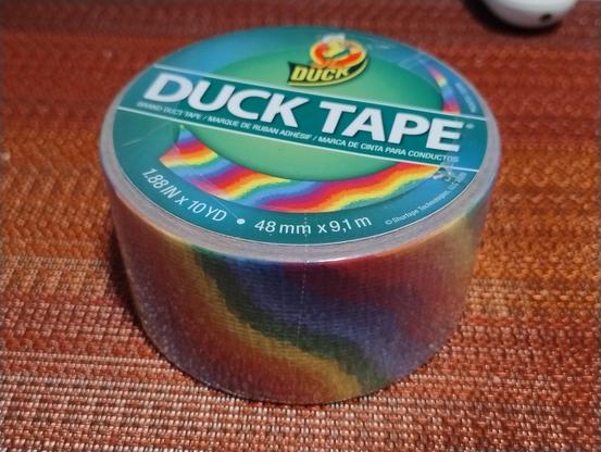 A roll of Duck Tape that's got a wavy rainbow pattern printed on it