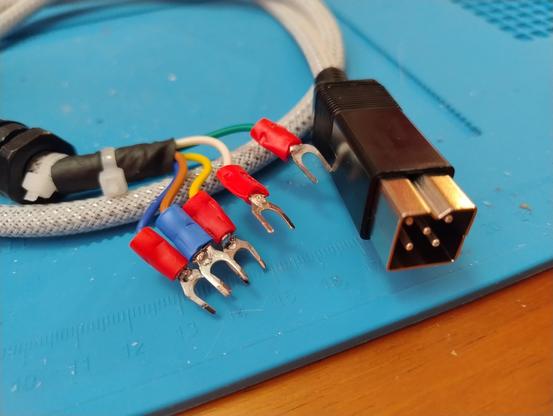 A square plug with five pins on one end of a cable and five wires ending in forked connectors on the other