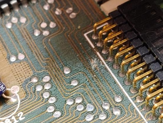 Close up section of an Amiga board with a scratch through one circuit track