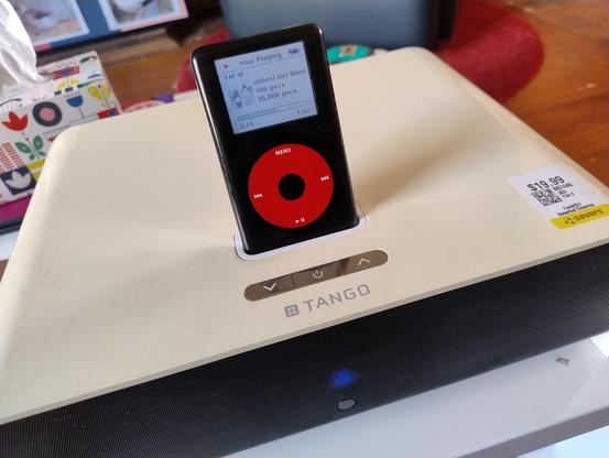 A black and red U2 special edition iPod in a beige XtremeMac speaker dock 