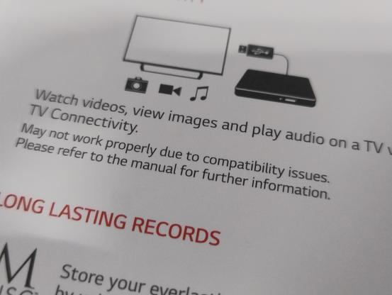 Back of a box illustrating a DVD writer and text saying 