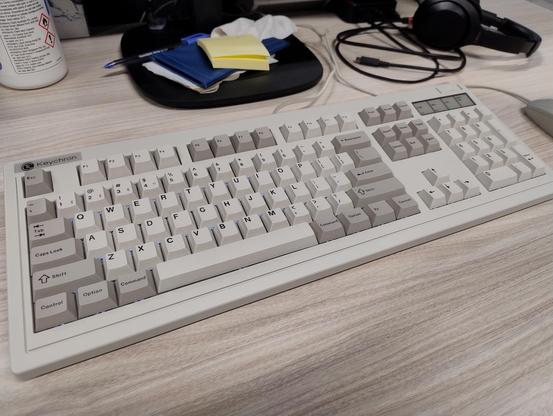A Keychron R6 keyboard on a desk, it's retro styled similar to an old IBM keyboard like the Model M in beige and grey. 