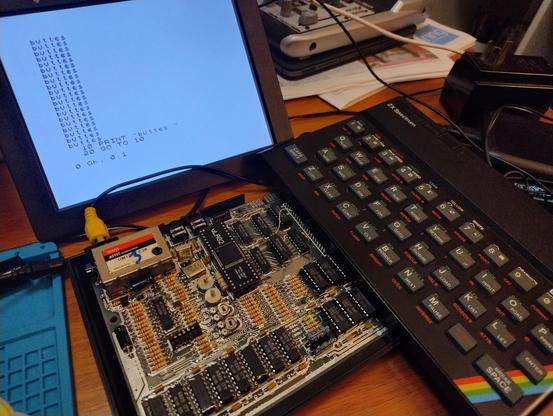 An opened up zx spectrum 48k with a replacement ULA chip fitted and 3 out of 8 ram chips replaced with C chips with bodge wires over the tops  Attached is a screen with a basic program to print 