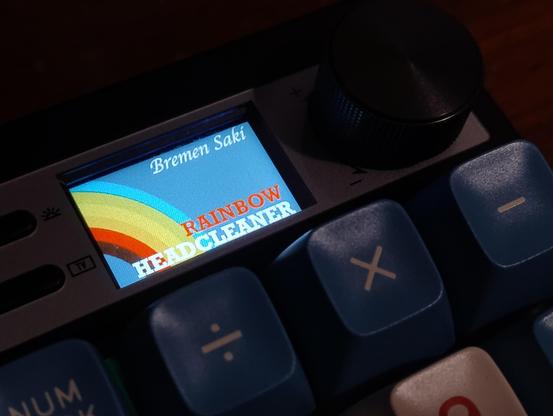 LCD screen on a keyboard showing a picture of a rainbow and the text 