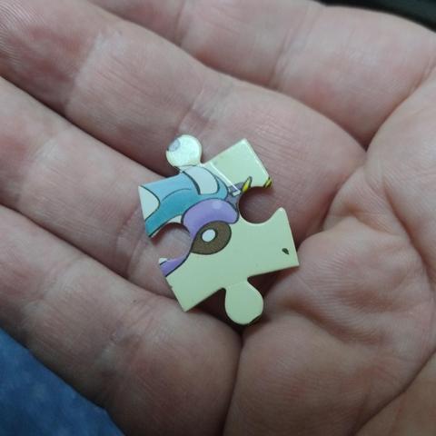 A single jigsaw puzzle piece with some bold colours, maybe it involves a cartoon character?