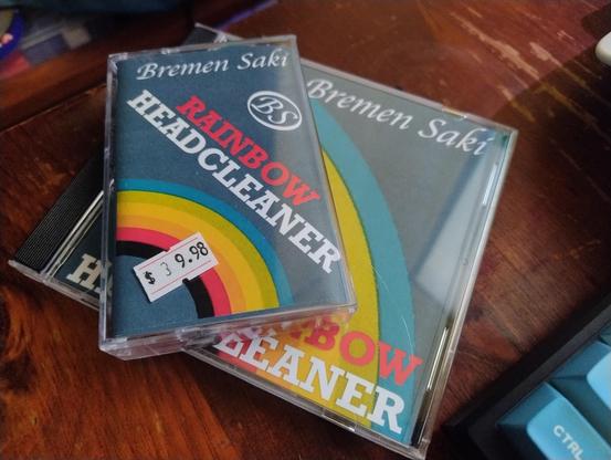 Audio cassette and CD cases with labels for Rainbow Headcleaner on them.