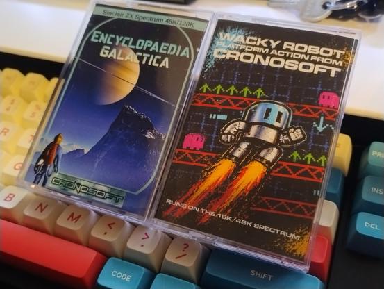 Two cassette cases, for the ZX Spectrum games Encyclopaedia Galactica and Wacky Robot, both from Cronosoft.