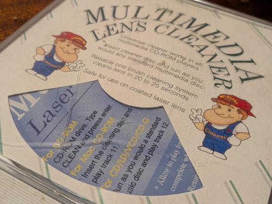 A CD jewel case labelled Multimedia Lens Cleaner with usage instructions 