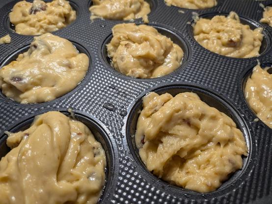 Uncooked muffin dough in a baking tray 