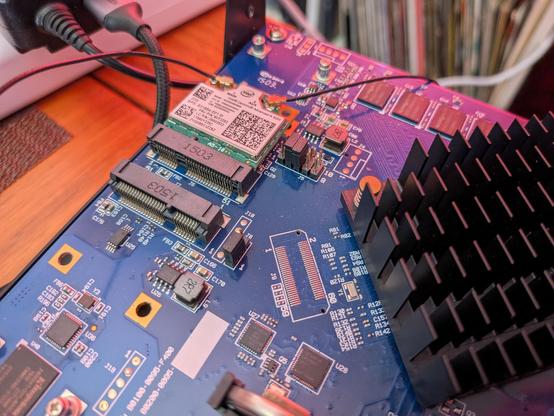 A small motherboard with a wifi card fitted and a couple of antenna cables running off from it